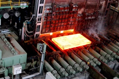 Vacuum hot-rolling press bonding stainless and carbon steel layers at about 1200 C